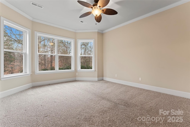 carpeted empty room featuring crown molding, a wealth of natural light, and ceiling fan