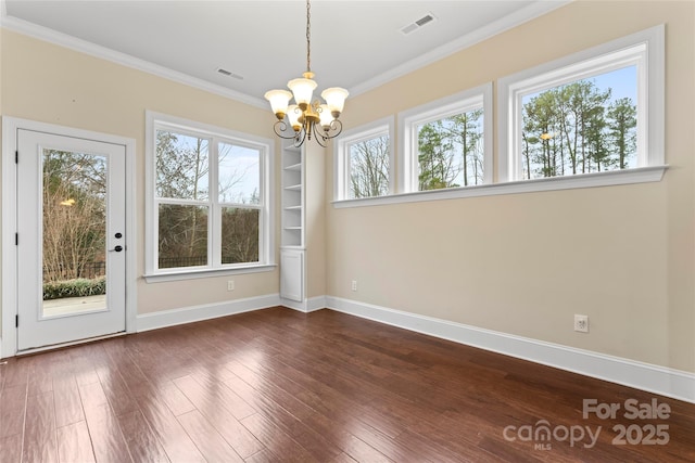 unfurnished dining area featuring a notable chandelier, crown molding, built in features, and dark hardwood / wood-style floors