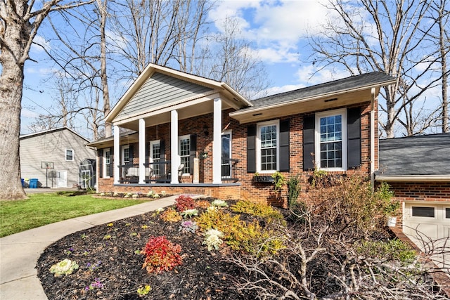 view of front of property with a garage, covered porch, and a front lawn