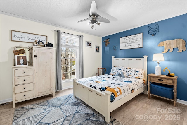 bedroom with crown molding, hardwood / wood-style flooring, and a textured ceiling