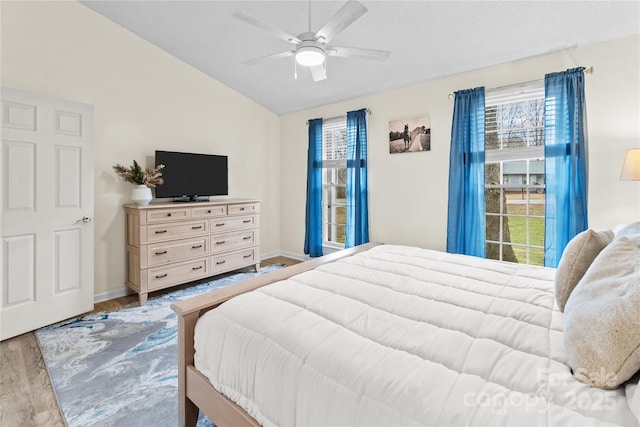 bedroom with vaulted ceiling, hardwood / wood-style floors, and ceiling fan