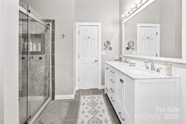 bathroom featuring tile patterned floors, vanity, and a shower with shower door