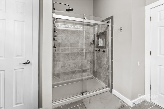 bathroom featuring a shower with shower door