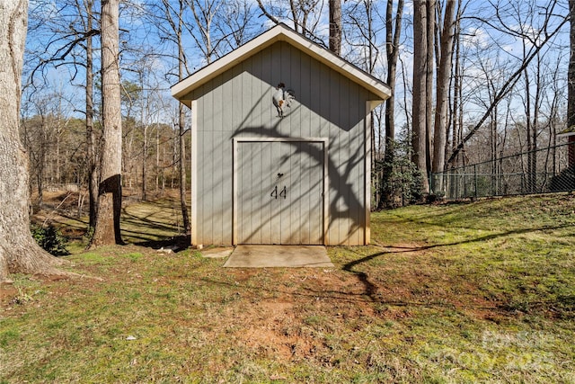 view of outbuilding featuring a lawn