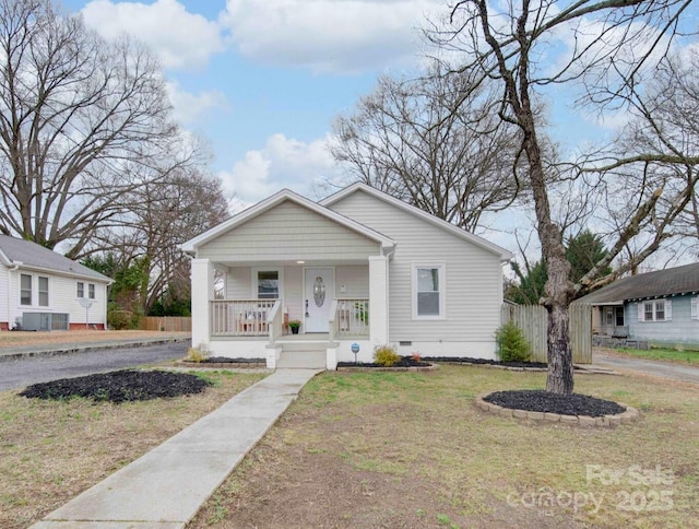 bungalow featuring a front lawn and a porch