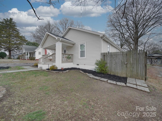 view of property exterior featuring a yard and covered porch