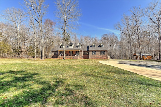 view of front facade with a front lawn and covered porch