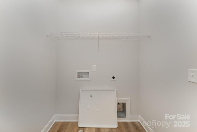 laundry area with electric dryer hookup, washer hookup, wood finished floors, baseboards, and laundry area