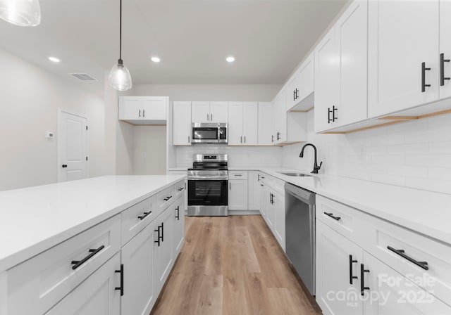 2825 New Pineola Rd Unit 7A, Charlotte, NC 28208 - kitchen featuring stainless steel appliances, white cabinets, decorative backsplash, and a sink
