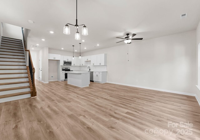 2825 New Pineola Rd Unit 7A, Charlotte, NC 28208 - unfurnished living room with recessed lighting, stairway, ceiling fan, light wood-style flooring, and baseboards