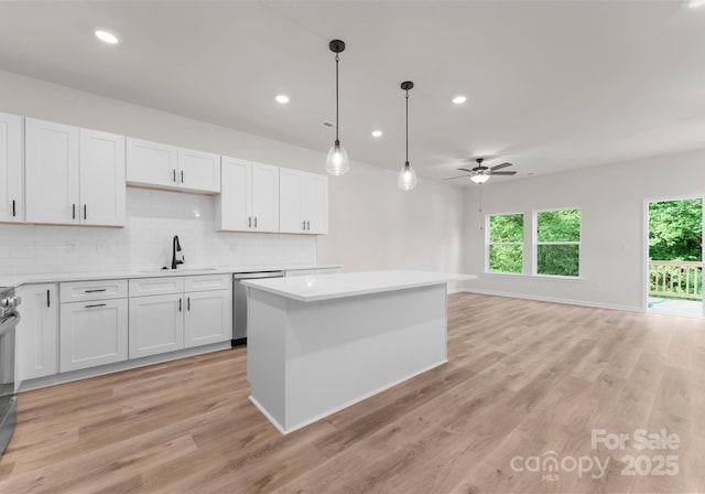2825 New Pineola Rd Unit 7A, Charlotte, NC 28208 - kitchen with a sink, dishwasher, backsplash, light countertops, and a ceiling fan