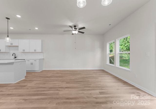 2825 New Pineola Rd Unit 7A, Charlotte, NC 28208 - unfurnished living room featuring a sink, light wood-type flooring, recessed lighting, a ceiling fan, and baseboards