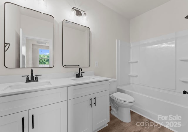 2825 New Pineola Rd Unit 7A, Charlotte, NC 28208 - bathroom featuring double vanity, toilet, wood finished floors, and a sink