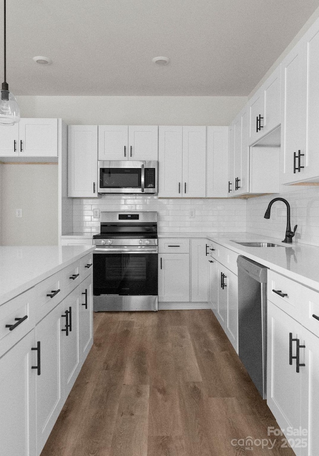 2825 New Pineola Rd Unit 7A, Charlotte, NC 28208 - kitchen with white cabinetry, stainless steel appliances, tasteful backsplash, and a sink