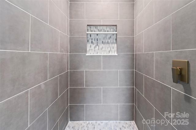 bathroom with a tile shower