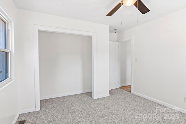 unfurnished bedroom with light carpet and ceiling fan