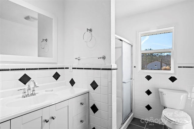 bathroom with vanity, toilet, tile patterned floors, and walk in shower