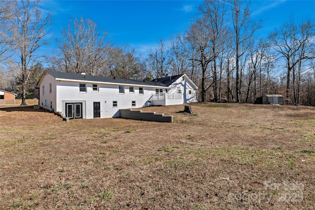 rear view of house with a yard