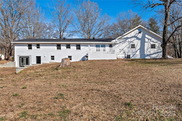 back of property with a lawn