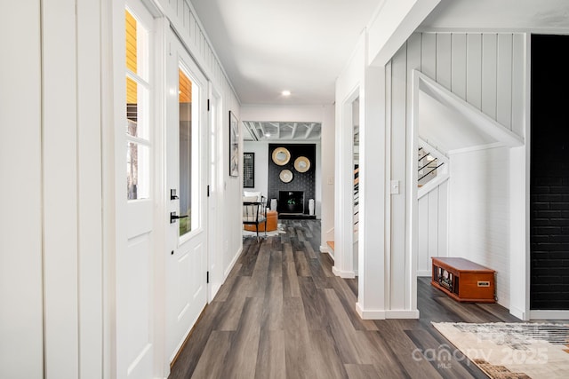 hallway with baseboards and dark wood-type flooring