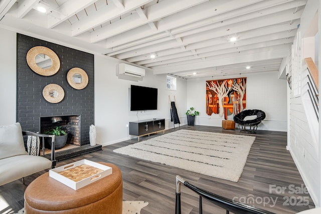 living area with a brick fireplace, baseboards, dark wood-style flooring, and a wall mounted air conditioner