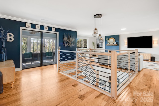 dining area featuring light wood-type flooring, baseboards, and ornamental molding