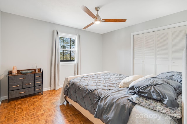 bedroom with a ceiling fan, a closet, and baseboards