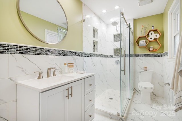 full bathroom featuring marble finish floor, vanity, and a marble finish shower