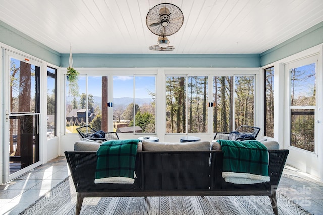 sunroom / solarium with wooden ceiling and a mountain view