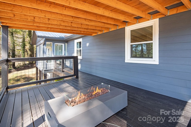 wooden terrace featuring a fire pit