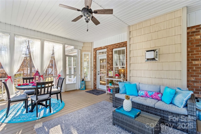 sunroom featuring ceiling fan