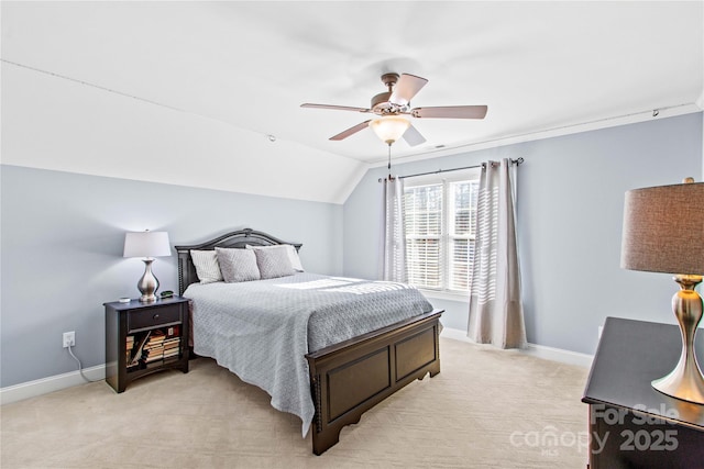 bedroom with lofted ceiling, light colored carpet, ceiling fan, and baseboards