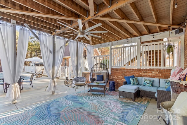 view of patio / terrace with a ceiling fan, outdoor lounge area, and stairs