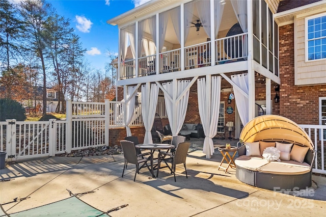 view of patio / terrace featuring ceiling fan, stairway, and a sunroom