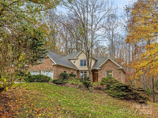 view of front of property featuring a garage and a front yard