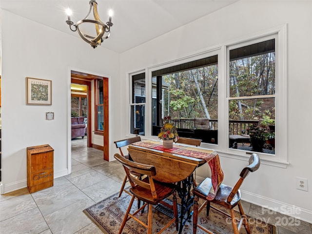 dining room featuring a wealth of natural light and an inviting chandelier