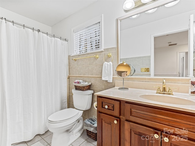 bathroom with tile patterned flooring, vanity, tile walls, and toilet