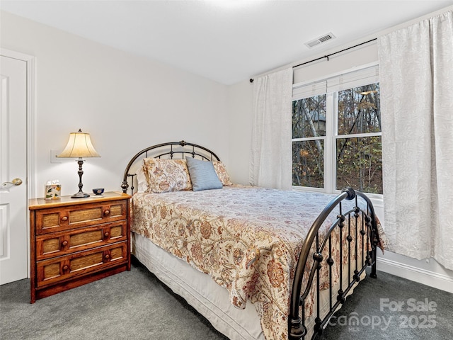 bedroom featuring dark colored carpet