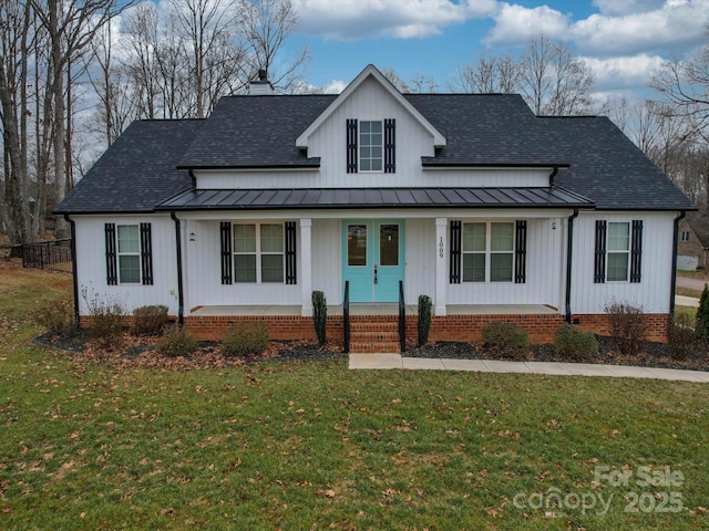 modern inspired farmhouse with a porch and a front lawn