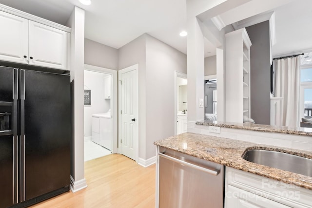 kitchen featuring light hardwood / wood-style flooring, dishwasher, white cabinetry, light stone countertops, and black refrigerator with ice dispenser