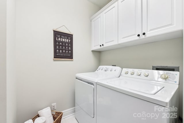 washroom with cabinets and washer and clothes dryer