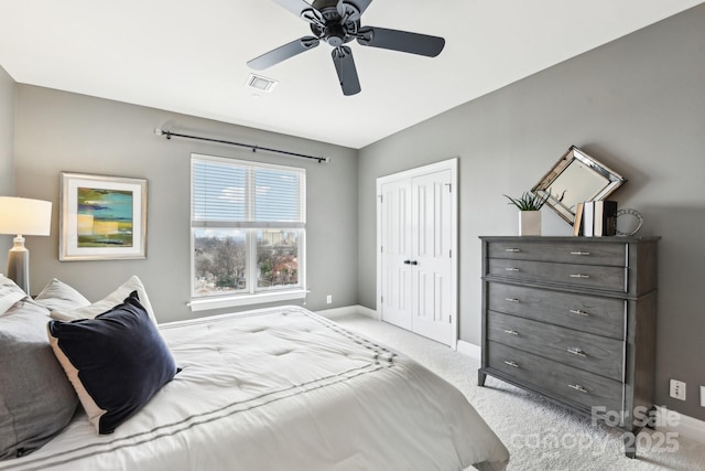 carpeted bedroom with a closet and ceiling fan