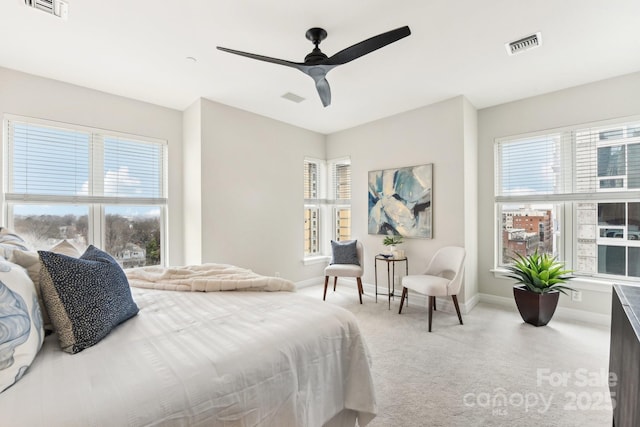 bedroom with multiple windows, carpet, and ceiling fan