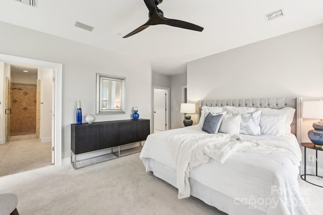 carpeted bedroom with ceiling fan and ensuite bath