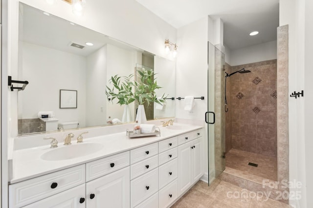 bathroom featuring vanity, tile patterned floors, toilet, and walk in shower