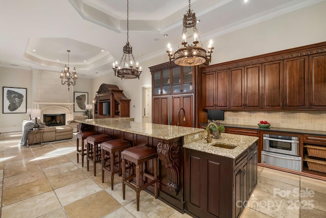2725 Windsor Rd, Winston Salem, NC 27104 - kitchen featuring a tray ceiling, a sink, a chandelier, oven, and a warming drawer