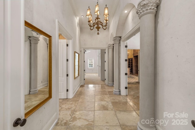 2725 Windsor Rd, Winston Salem, NC 27104 - hallway featuring stone tile flooring, crown molding, a chandelier, and baseboards