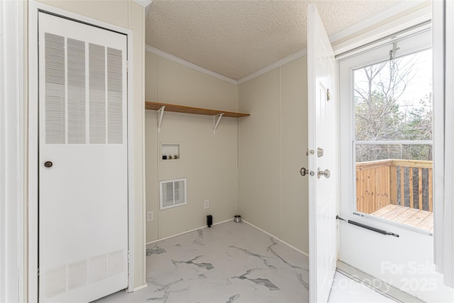 laundry area featuring hookup for a washing machine, ornamental molding, and a textured ceiling