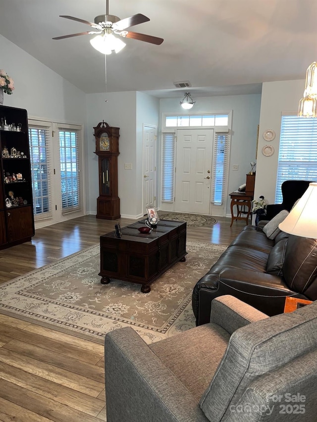 living room featuring lofted ceiling, hardwood / wood-style flooring, and ceiling fan