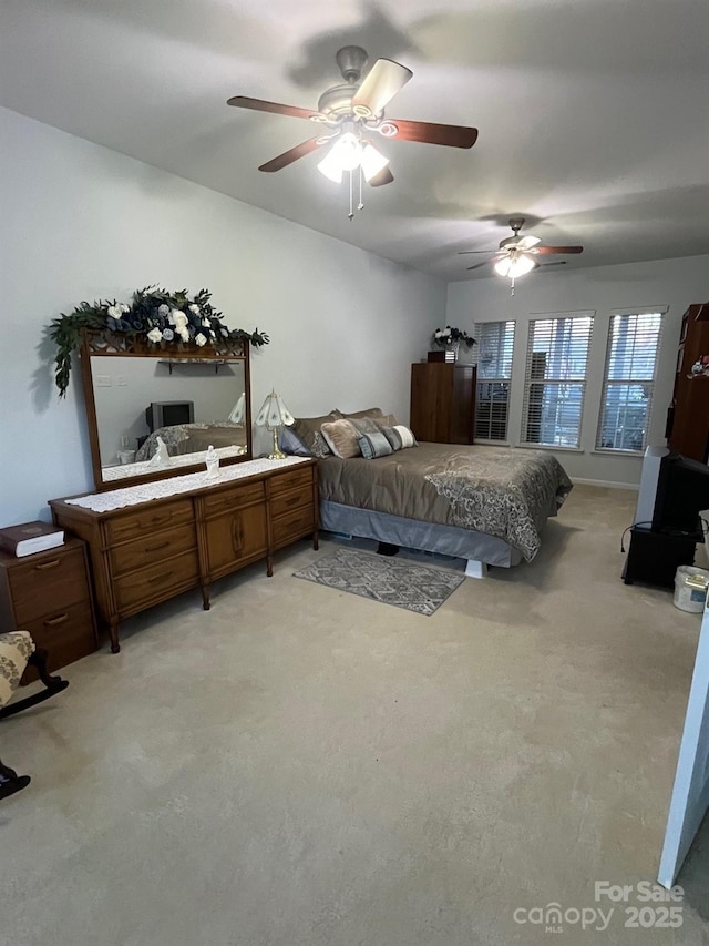 bedroom featuring light colored carpet and ceiling fan